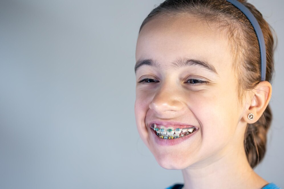 Teenage girl with braces on her teeth closeup of a smile